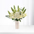 White lilies and hydrangeas in minimalist vase with bilingual message.