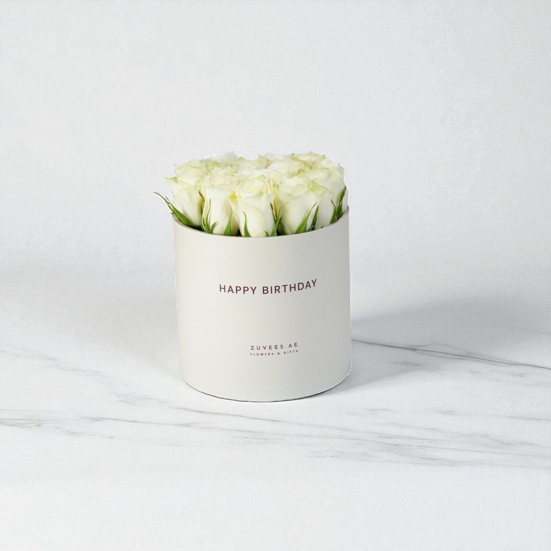 White roses in elegant cream box, "Happy Birthday" text, marble background, minimalist luxury gift.