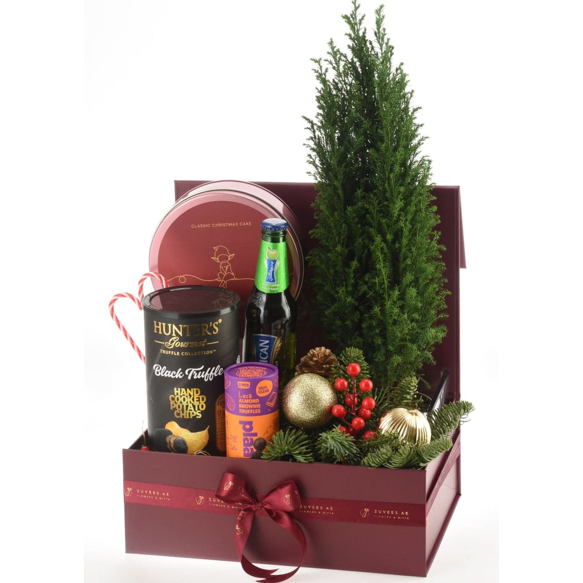 Luxurious burgundy gift box with festive greenery, candy cane, and gourmet treats.
