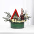 Emerald green holiday gift basket with champagne, candles, and festive white florals.