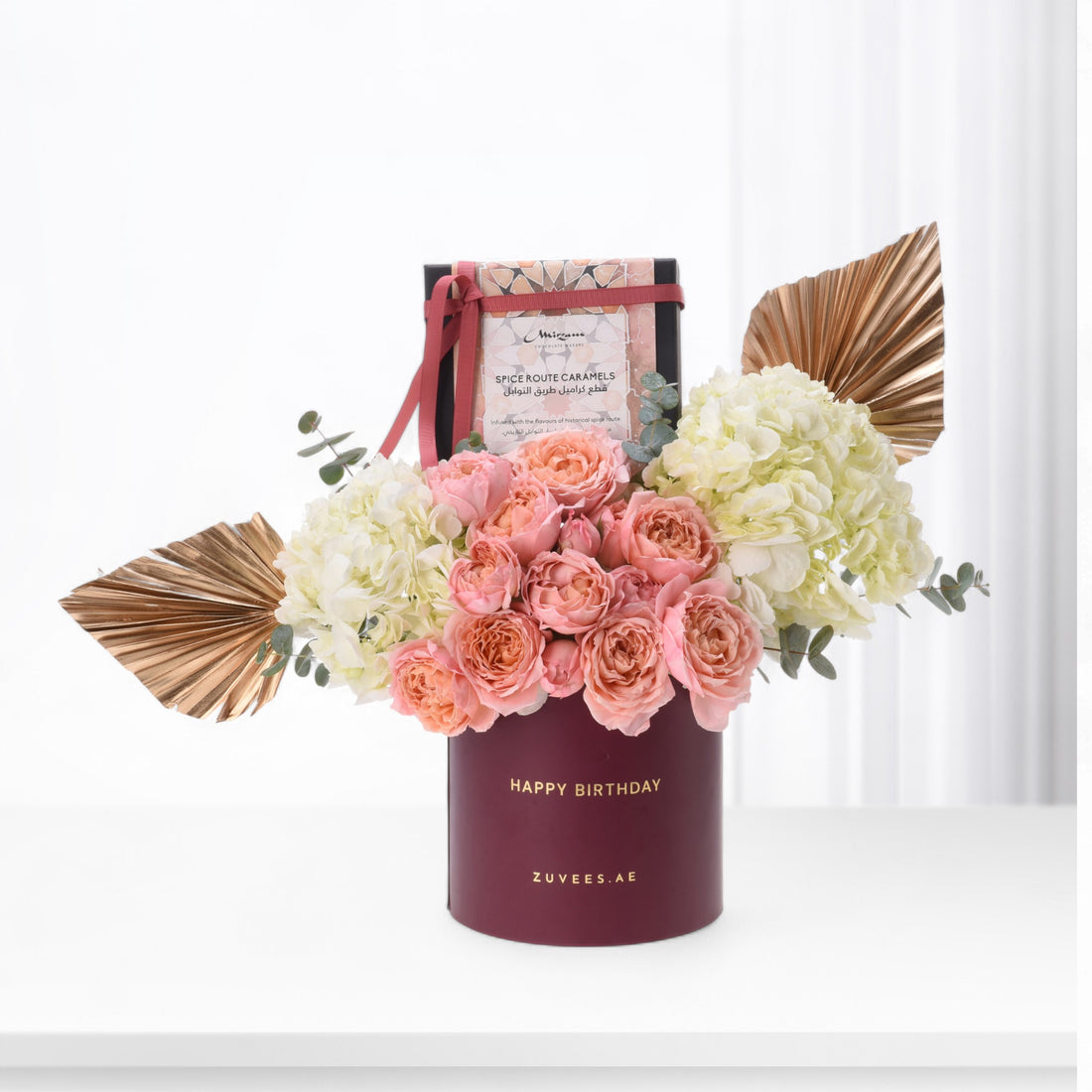 Elegant burgundy birthday bouquet with pink roses, cream hydrangeas, and gold accents.