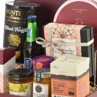 Luxury gourmet gift hamper with truffle chips, coffee, honey, and festive dates.