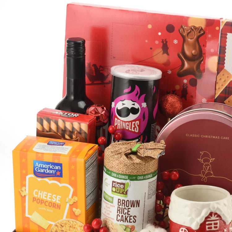 Vibrant holiday snack gift set with red, gold, and festive treats.