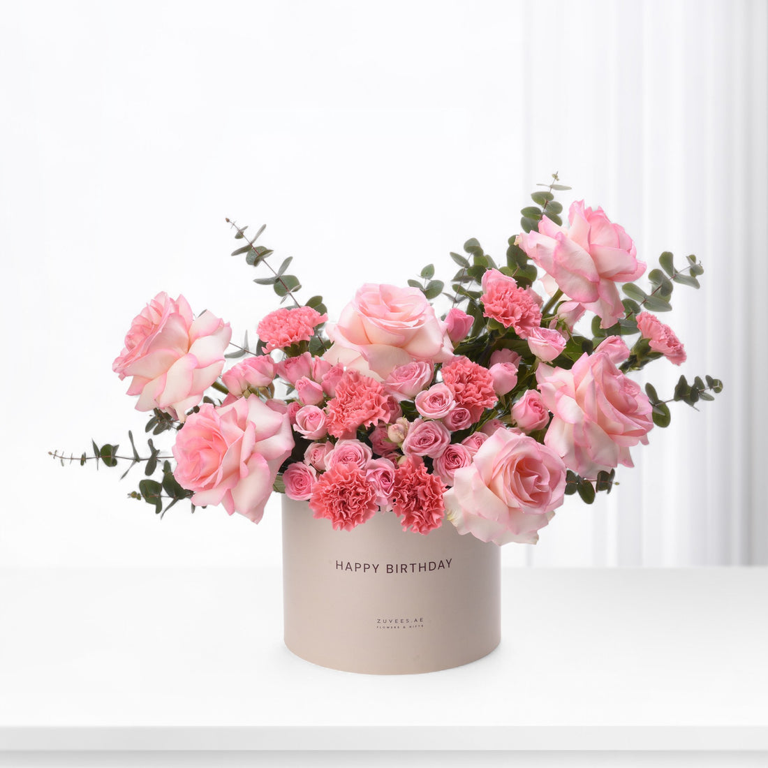 Soft pink roses and carnations in beige "Happy Birthday" box.