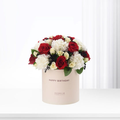 Elegant red and white roses in beige box with "Happy Birthday" text.