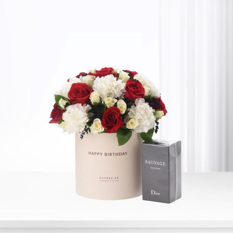 Red and white roses with carnations in beige "Happy Birthday" box beside Dior Sauvage perfume.