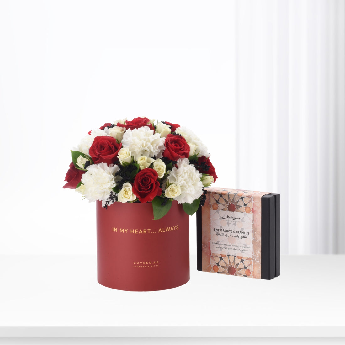 Red velvet box with roses and caramels, elegant gift set.