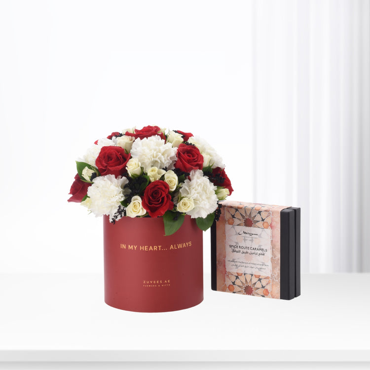Red velvet box with roses and caramels, elegant gift set.