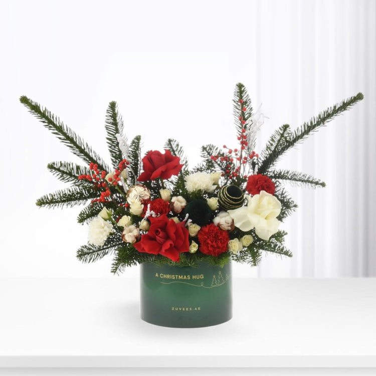 Vibrant red and white blooms nestled in festive green pine, adorned with berries and ornaments in elegant holiday-themed container.