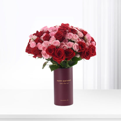 Luxurious red and pink roses in burgundy "Happy Birthday" vase, elegant gift for celebrations.