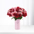 Vibrant red and pink roses in light pink “It’s a Girl” vase.