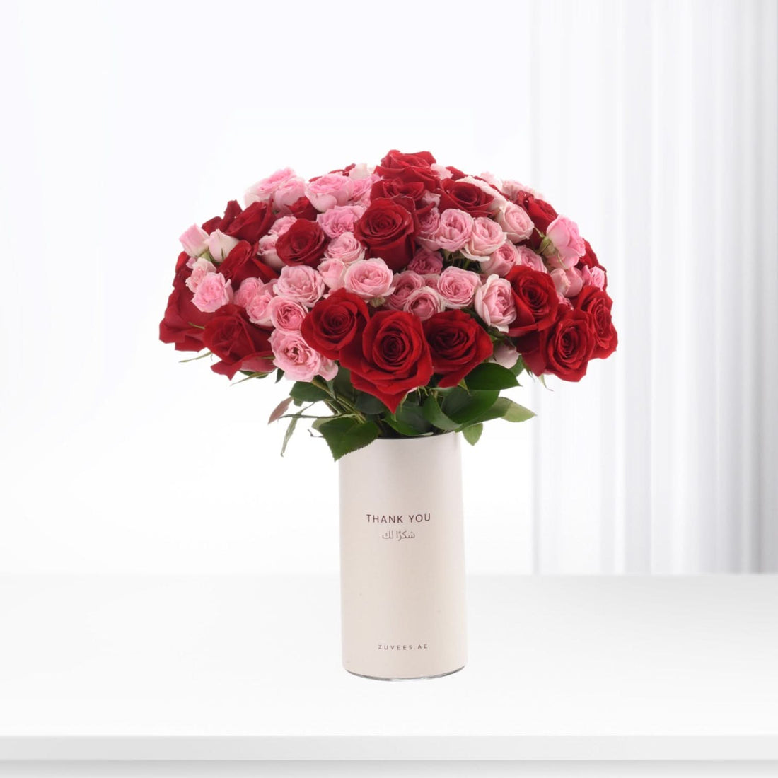 Red and pink roses in white vase, "Thank You" text, elegant gift bouquet.