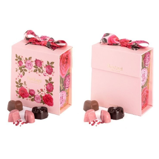 Pink rose-themed chocolate gift boxes with ribbon bows and assorted truffles.