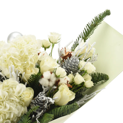 White roses and hydrangeas with snowy pinecones and evergreens in soft green wrap.