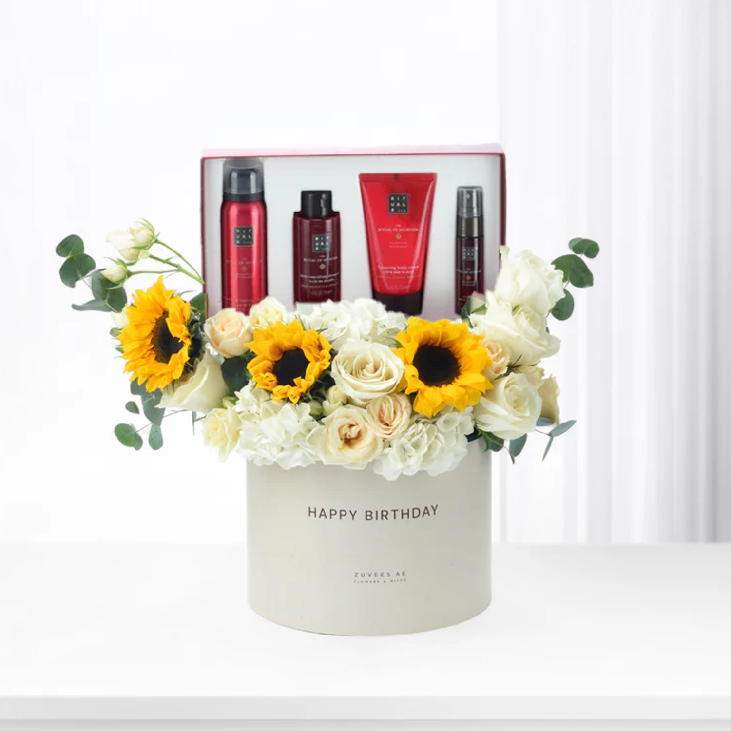 White box with sunflowers, roses, and Rituals gift set for birthday.