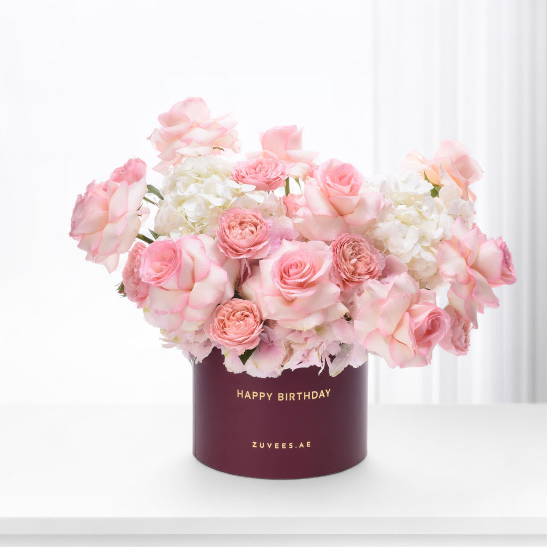 Soft pink roses and hydrangeas in burgundy "Happy Birthday" box.