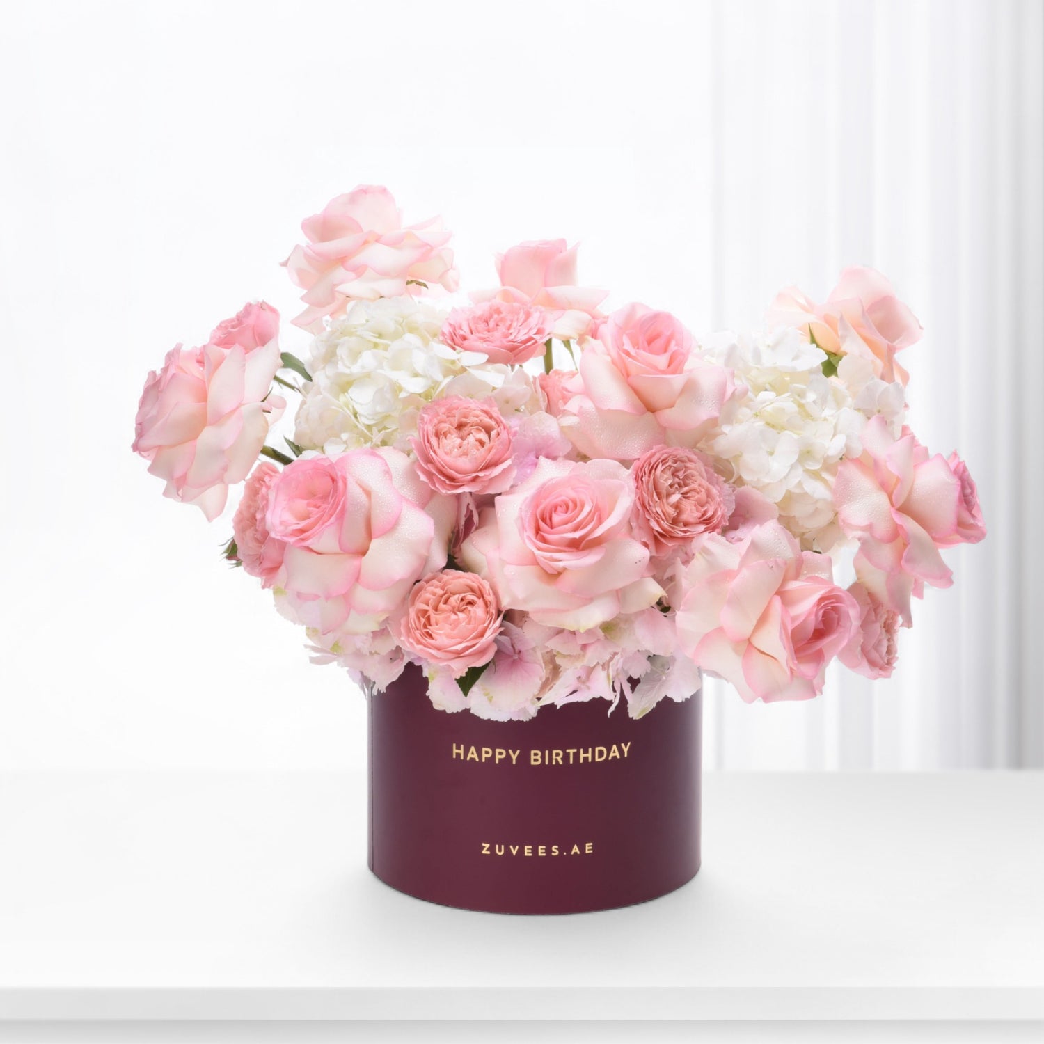 Soft pink roses and hydrangeas in burgundy "Happy Birthday" box.