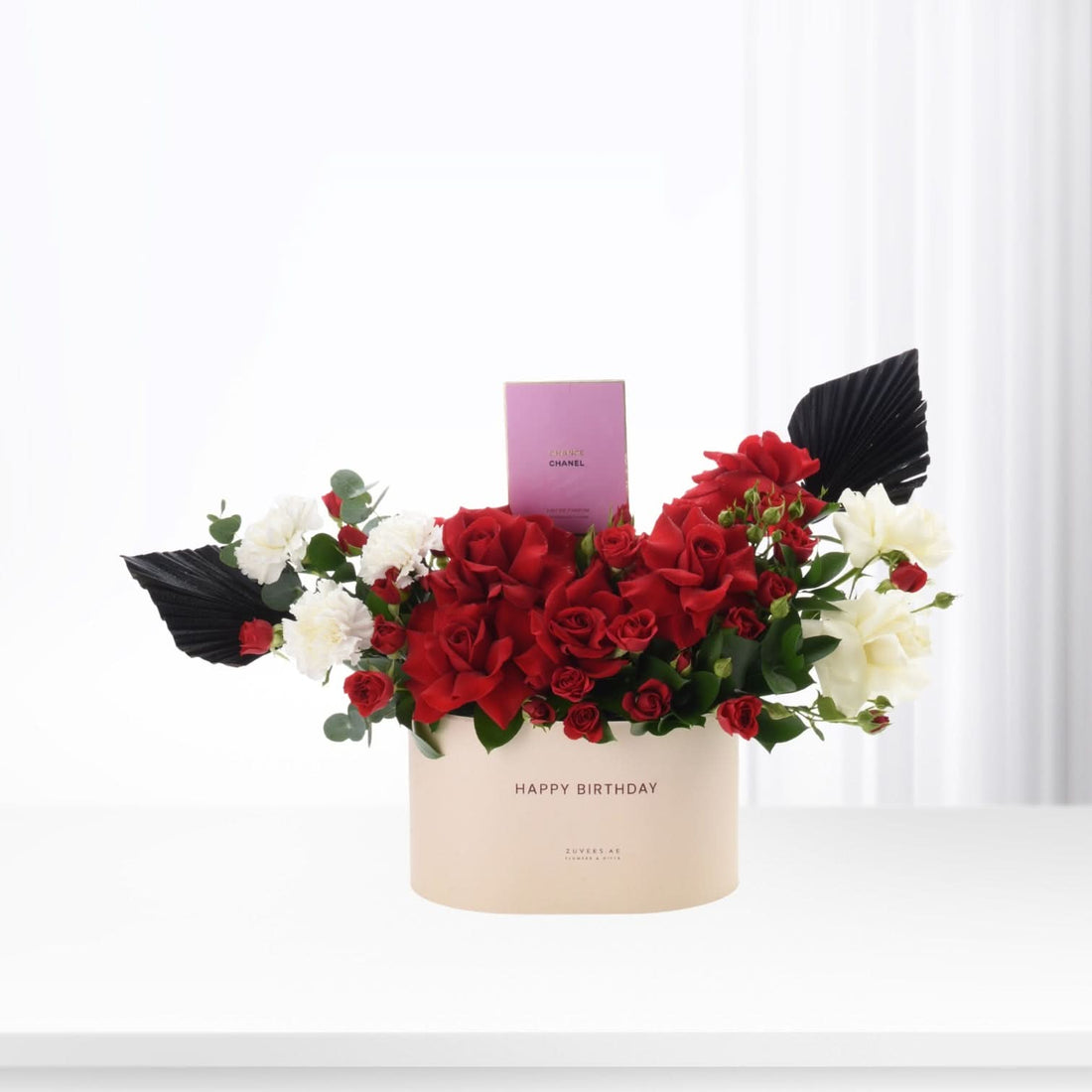 Red and white roses with black leaves in cream "Happy Birthday" box, Chanel perfume gift.