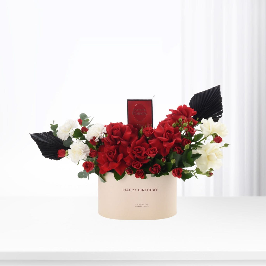 Elegant red and white roses in beige box with "Happy Birthday" and Dior perfume.