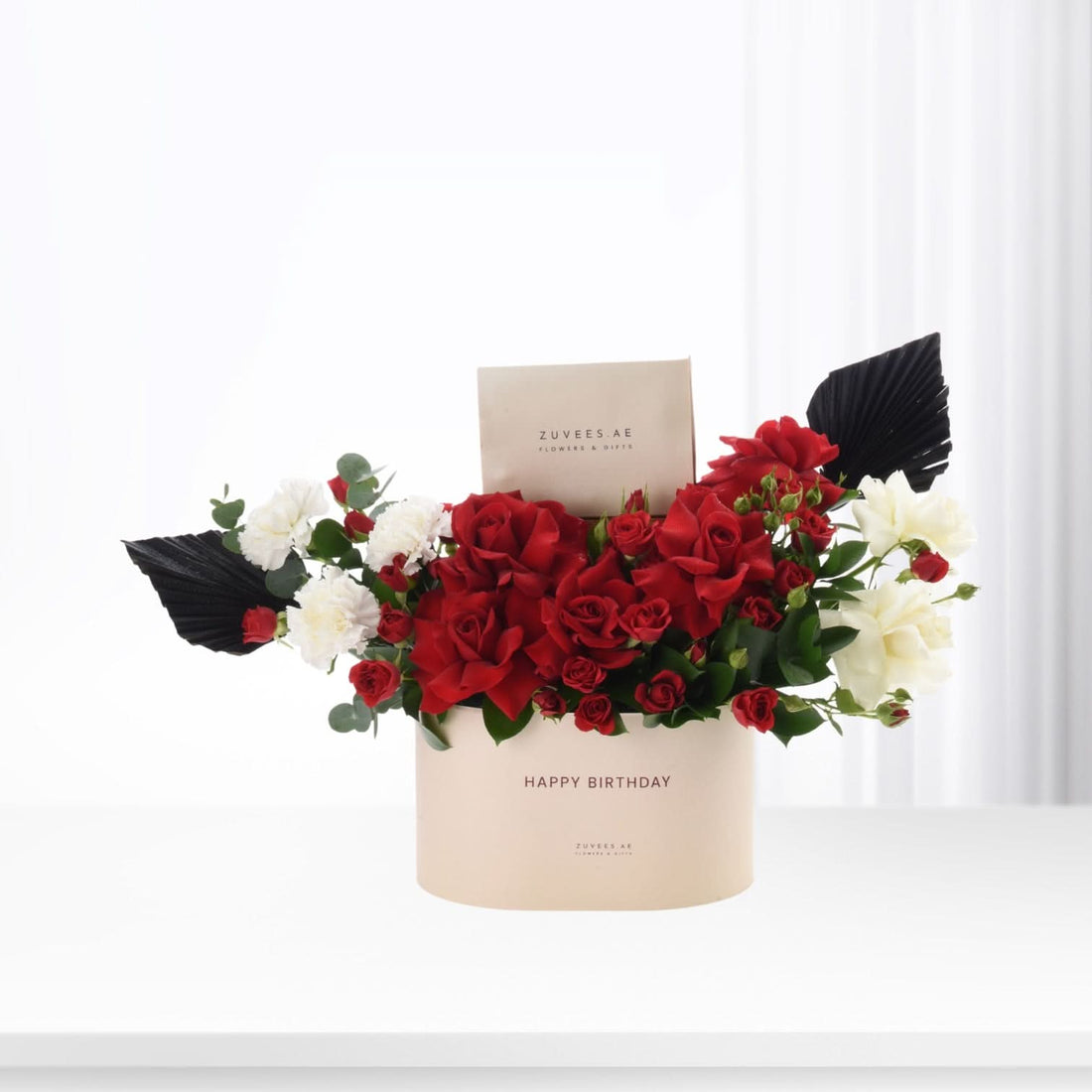 Elegant red and white roses in beige box with "Happy Birthday" text.
