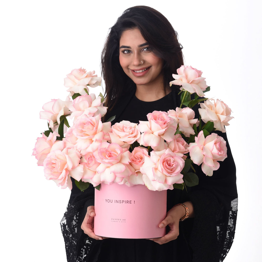 Pink roses overflow from a matching box reading "YOU INSPIRE!"