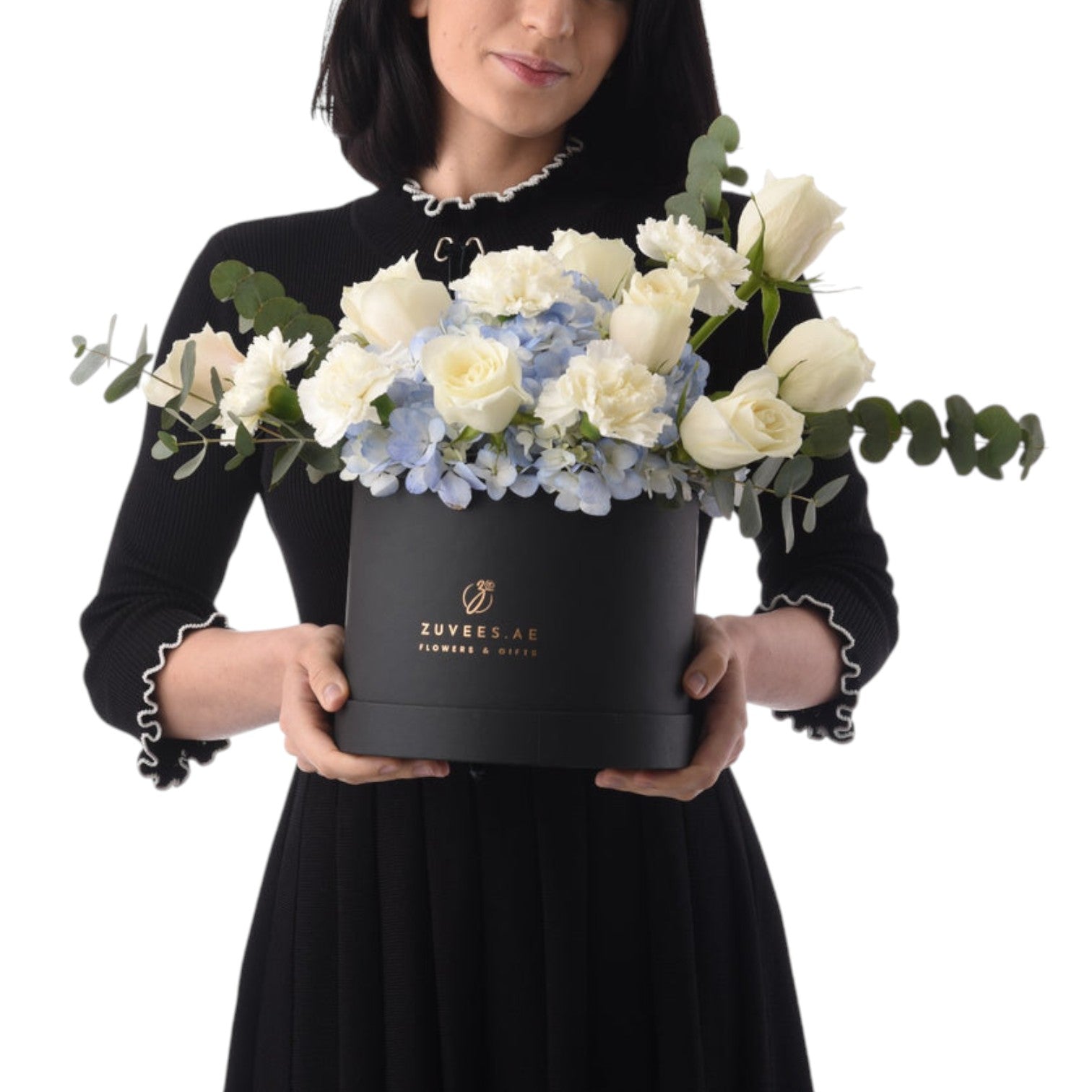Elegant white roses, blue hydrangeas, and eucalyptus in a sleek black Zuvees gift box.