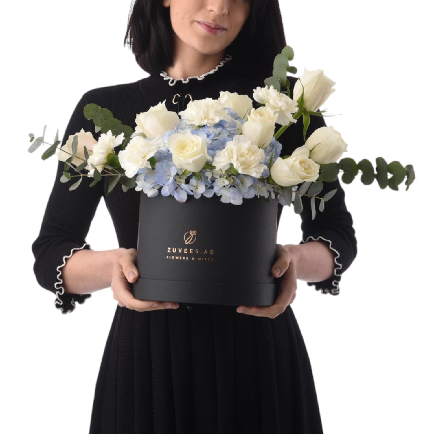 Elegant white roses, blue hydrangeas, and eucalyptus in a sleek black Zuvees gift box.