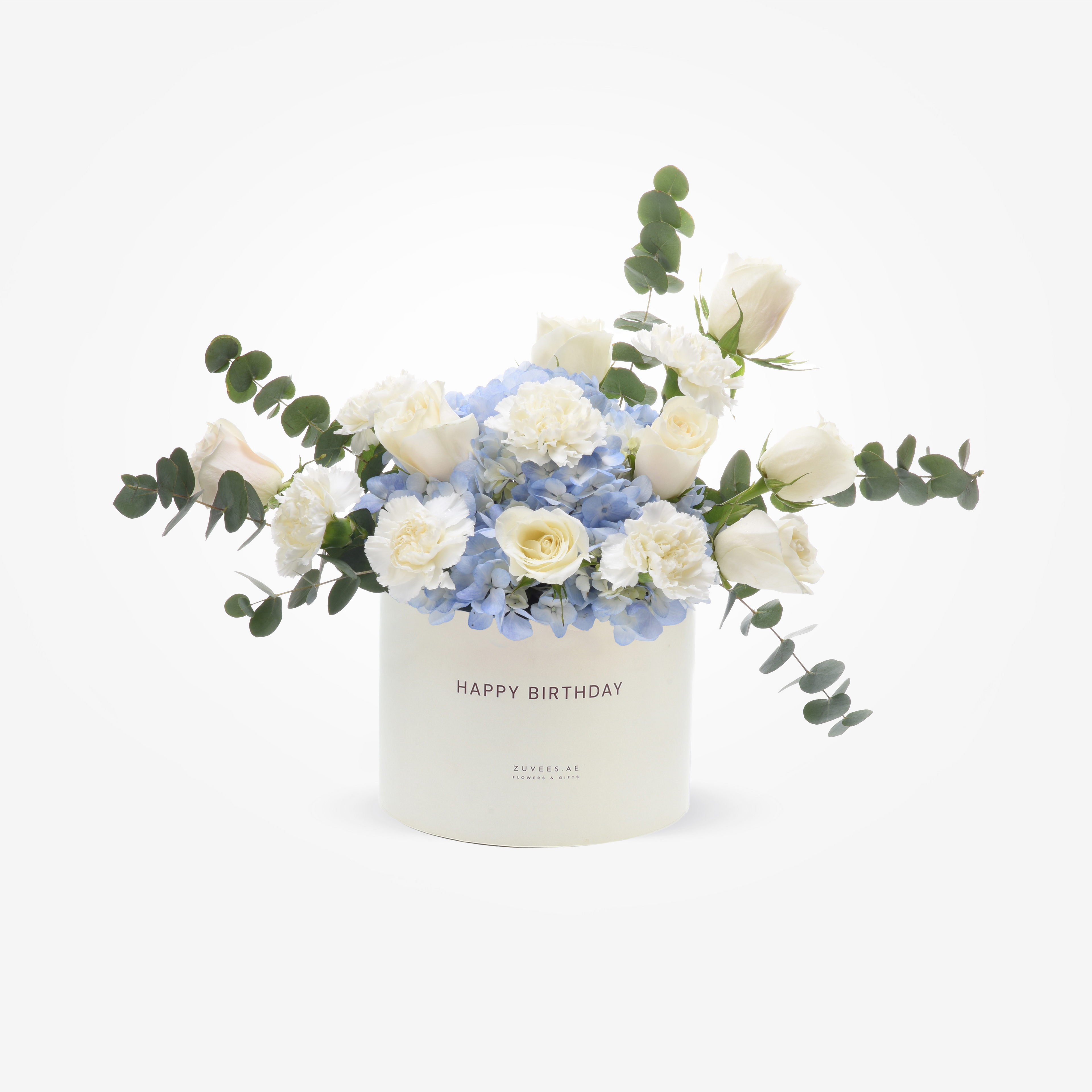 Elegant white rose and hydrangea bouquet in a "Happy Birthday" cylinder, accented with eucalyptus.