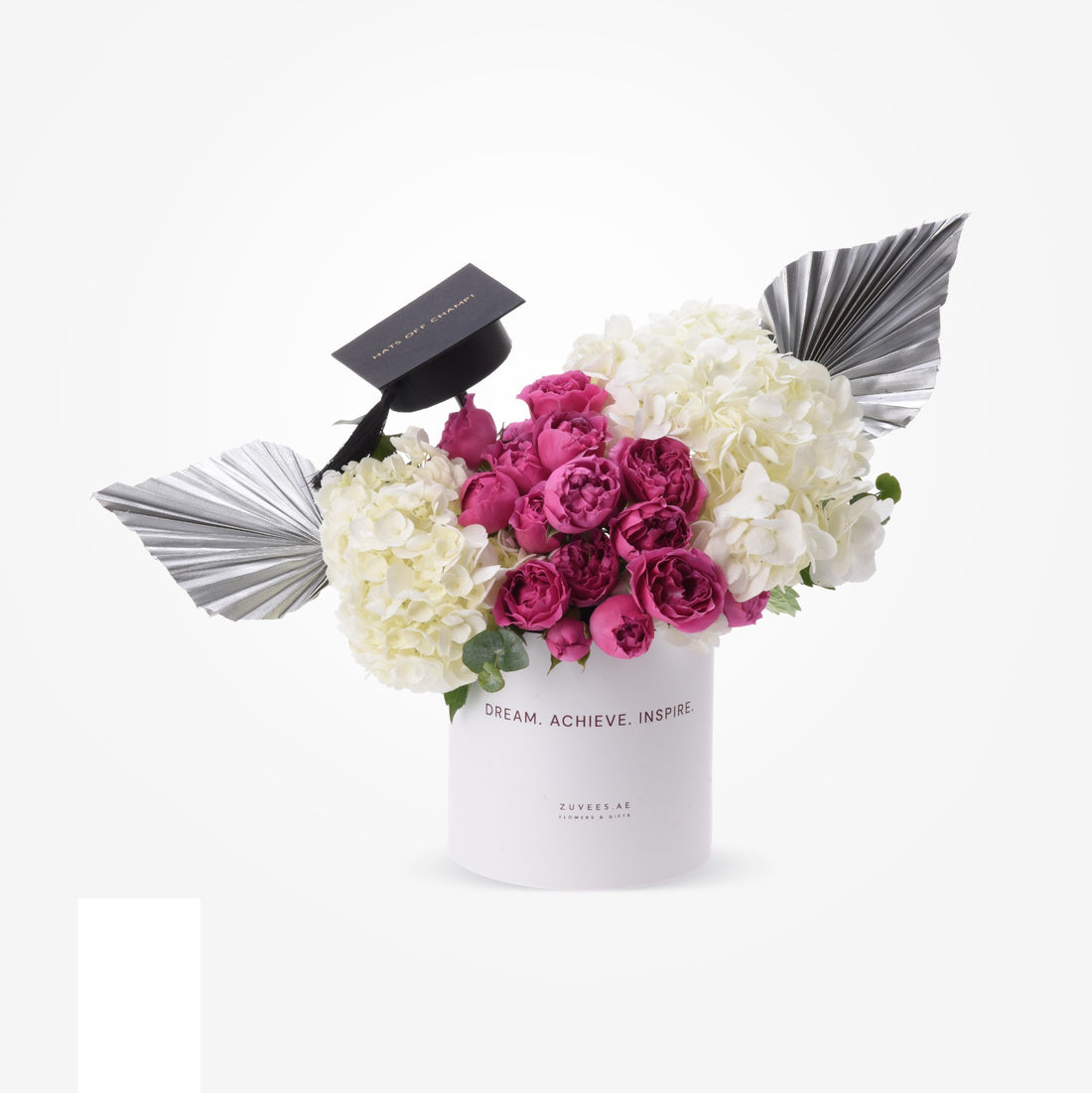 White cylindrical vase with pink roses and hydrangeas, graduation cap, silver fan accents.