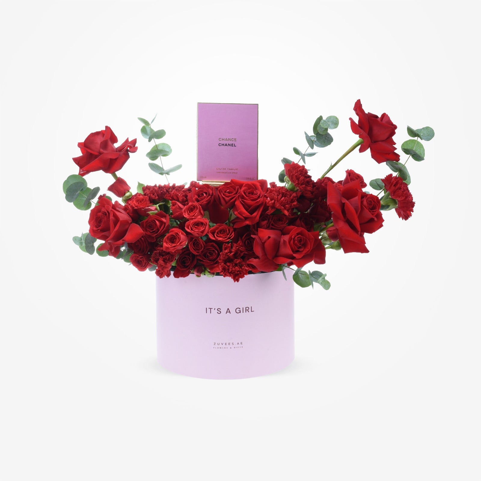 Vibrant red roses and carnations spill from a lavender "It&
