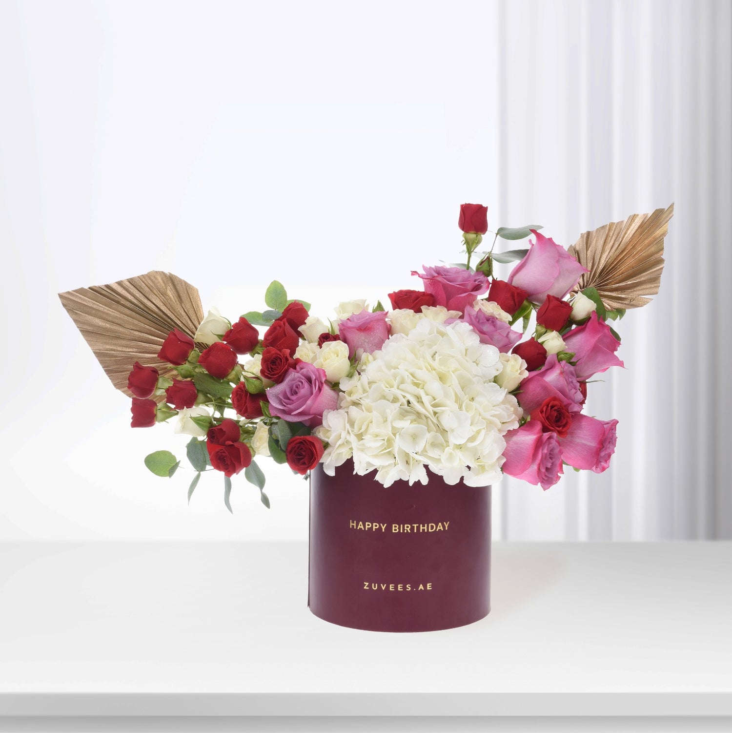 Luxury birthday bouquet: red, pink, white roses &amp; hydrangeas in burgundy box with gold text.