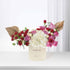 Cream box holds vibrant red, pink, white roses and hydrangeas, accented with gold fan leaves.