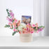 Pastel pink roses, hydrangeas, and eucalyptus in cream box with "Happy Birthday" and massage voucher.