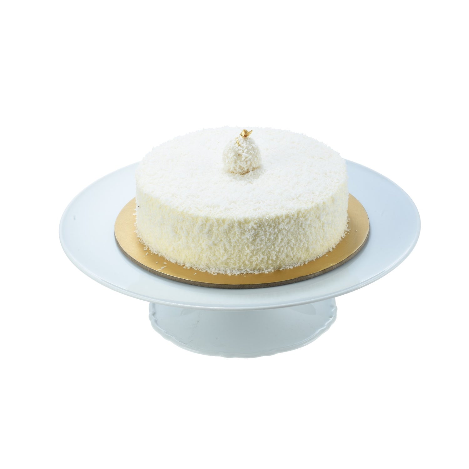 White coconut cake on gold base, topped with gold leaf, elegant presentation.