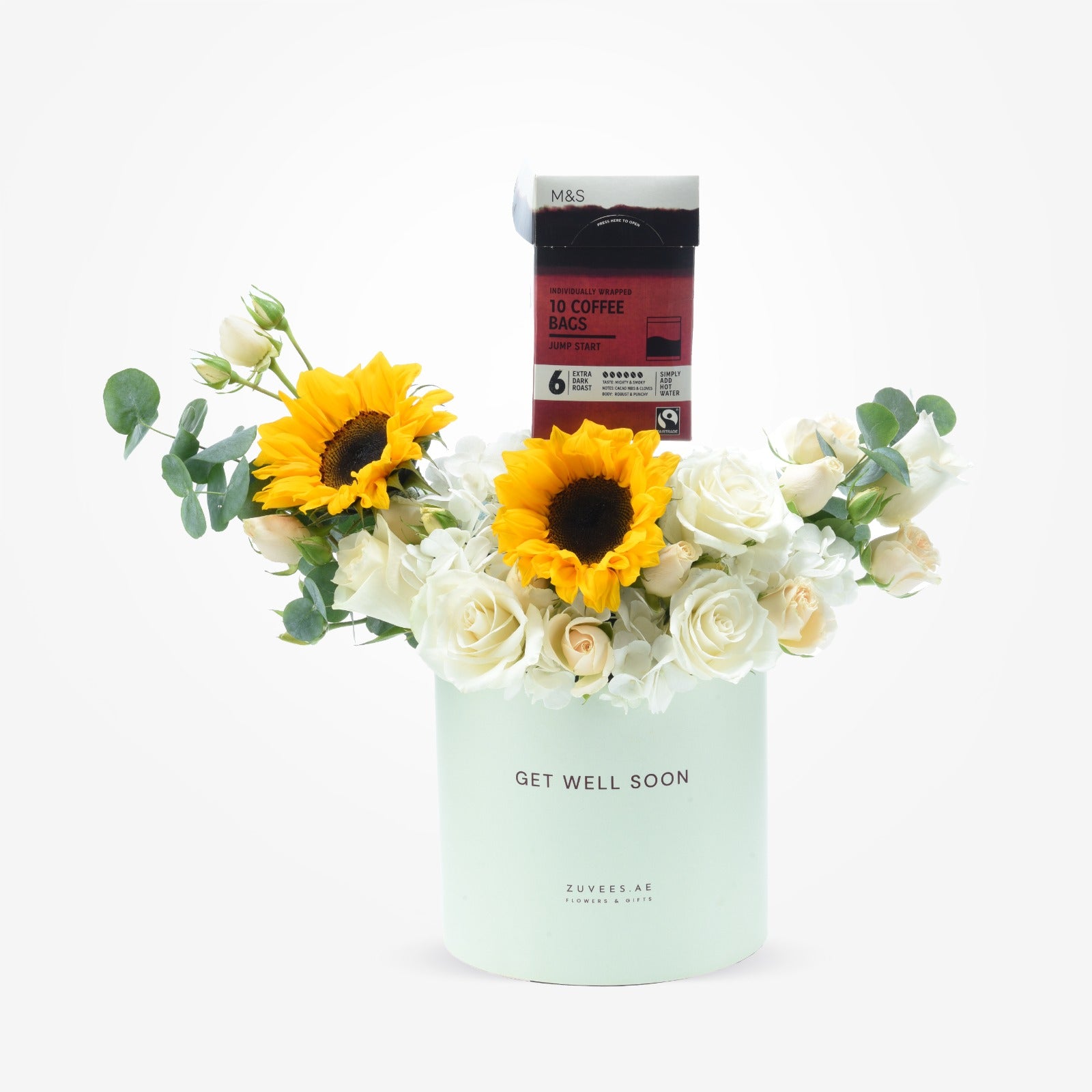 Pastel mint vase with white roses, sunflowers, and coffee box reading "Get Well Soon".