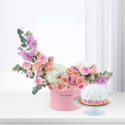 Pink floral arrangement and cake in soft pastels, elegant gift set.