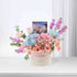 Pastel pink roses, blue hydrangeas, and purple blooms in cream box with "Happy Birthday" text.
