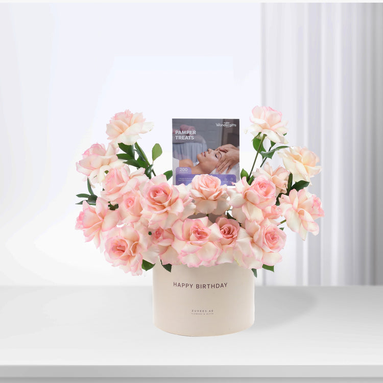 Soft pink roses in cream vase with "Happy Birthday" and pamper treats card.