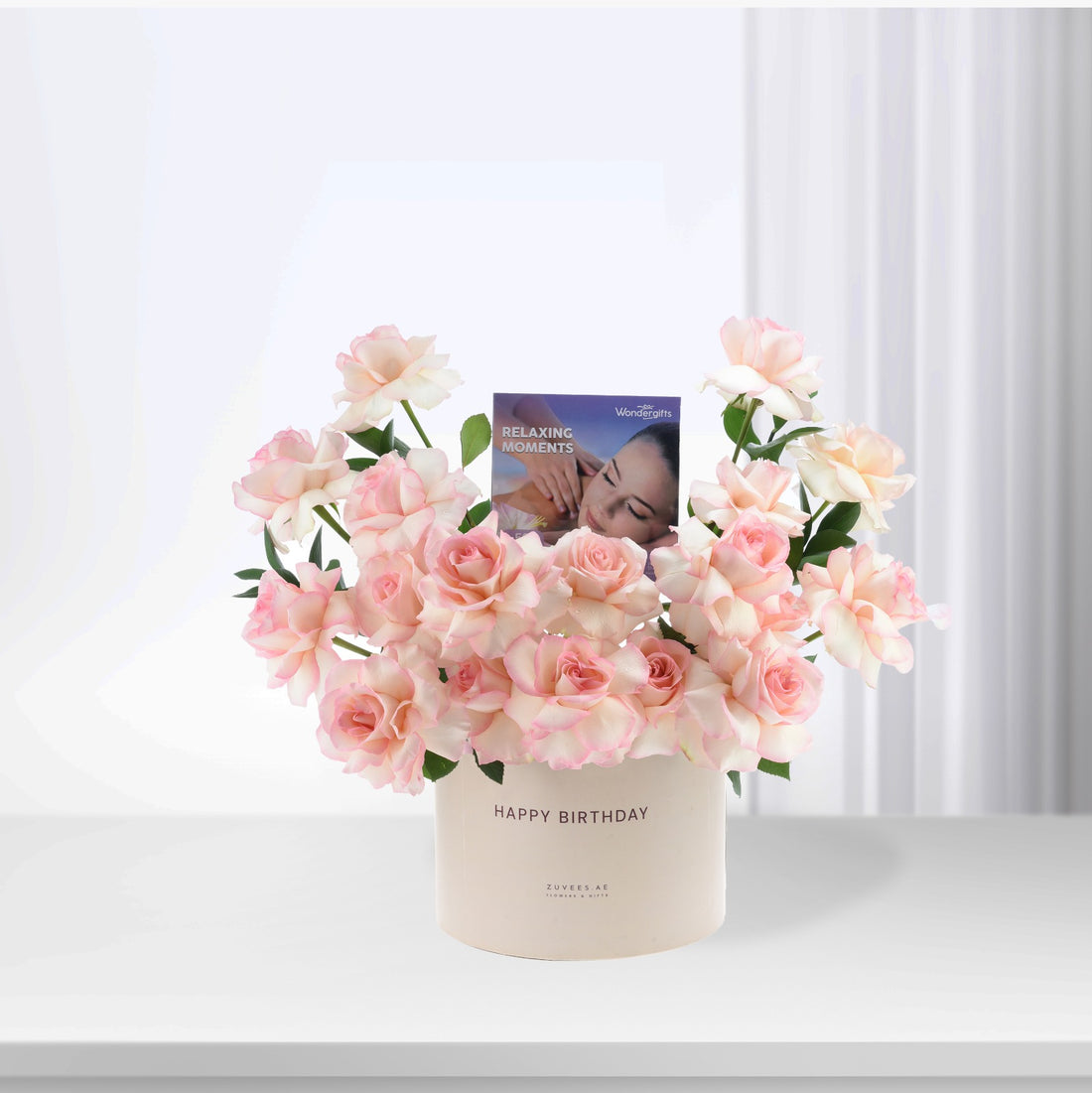 Soft pink roses in cream vase with "Happy Birthday" and relaxing moments card.