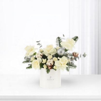 Elegant white roses, cotton, eucalyptus, pine, silver ornament in minimalist white vase.