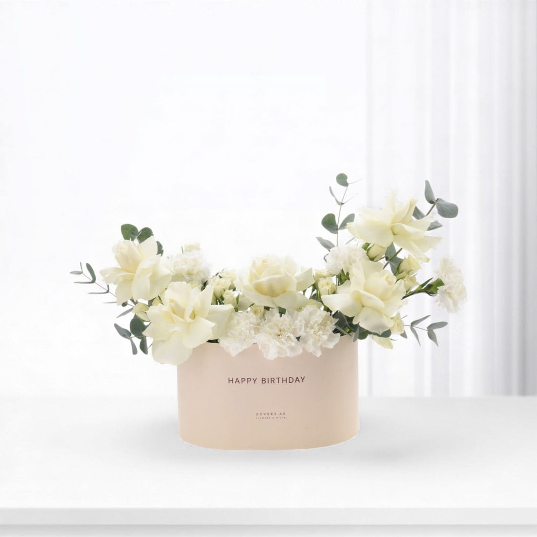 Elegant white roses, carnations, eucalyptus in blush "Happy Birthday" box, minimalist chic.