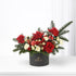 Festive red roses, white carnations, pine, ornaments in sleek black Zuvees box, holiday elegance.