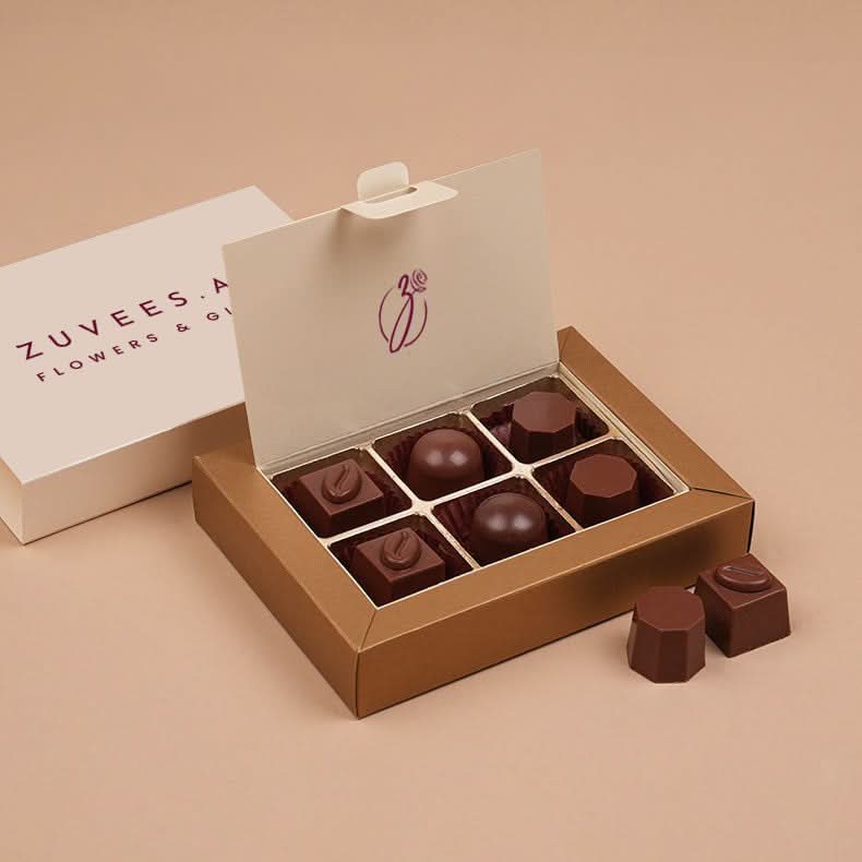 Luxury chocolate box with elegant branding and assorted shapes.