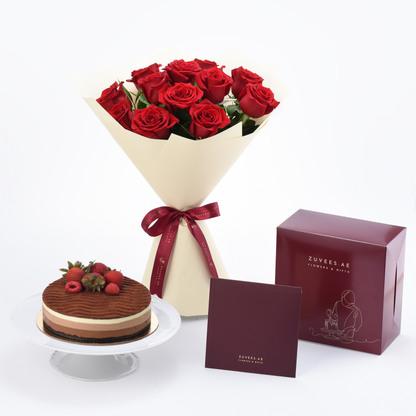 Vibrant red roses in cream wrap with chocolate cake and branded gift box.