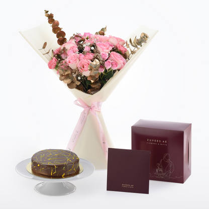 Pink roses and eucalyptus bouquet with chocolate cake, elegant burgundy gift box.