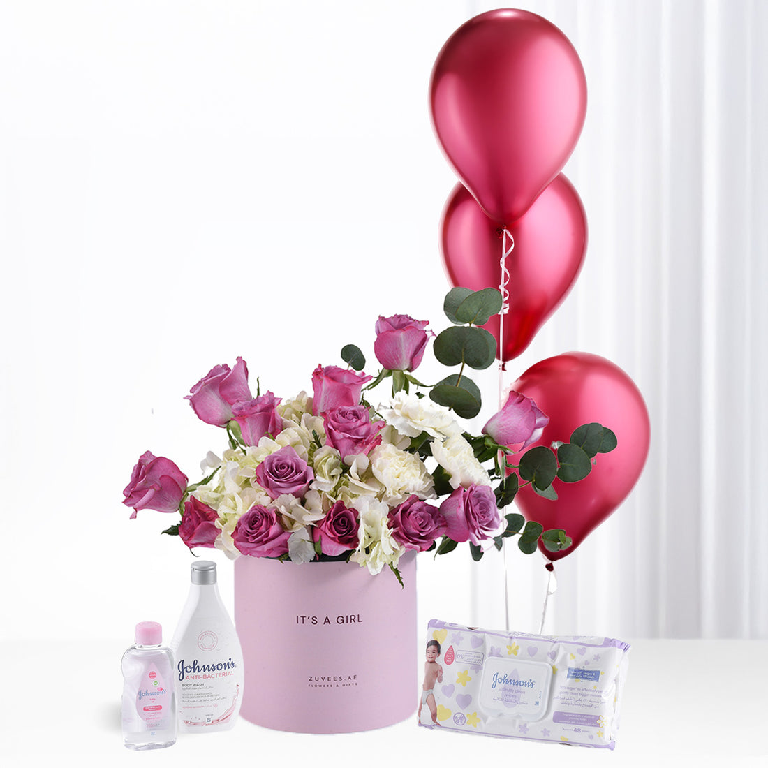 Pink roses and balloons celebrate baby girl arrival with Johnson’s baby essentials.