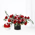 Vibrant red and pink roses with eucalyptus, paired with a red velvet cake.
