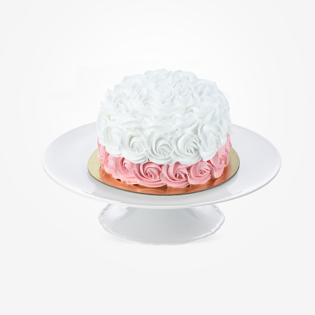 White and pink rose-frosted cake on elegant white pedestal stand, perfect for celebrations.