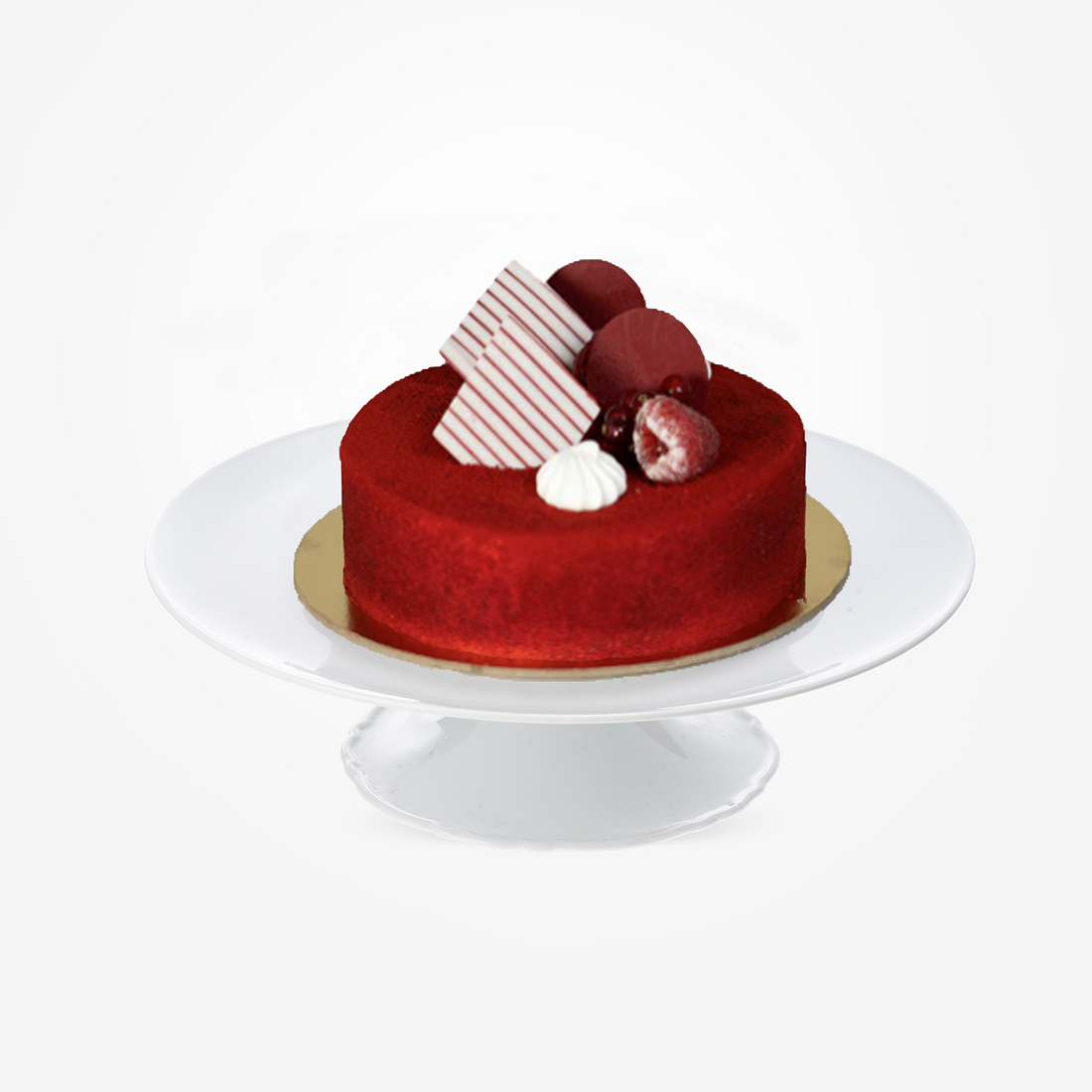 Vibrant red velvet cake with raspberries, striped chocolate, and cream on white pedestal.