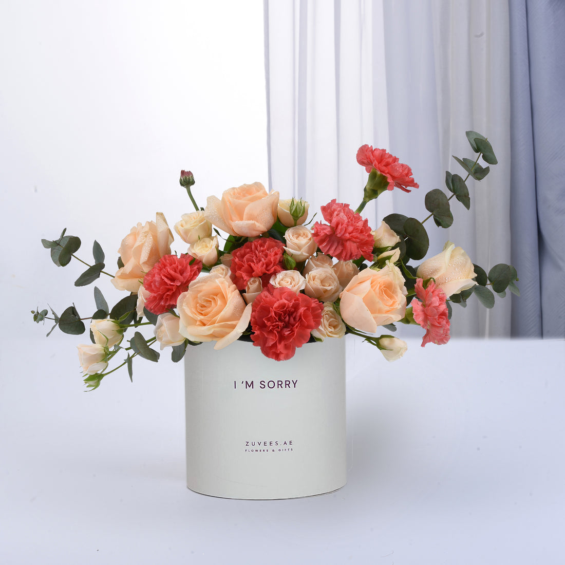 Peach roses, coral carnations, eucalyptus in white "I&